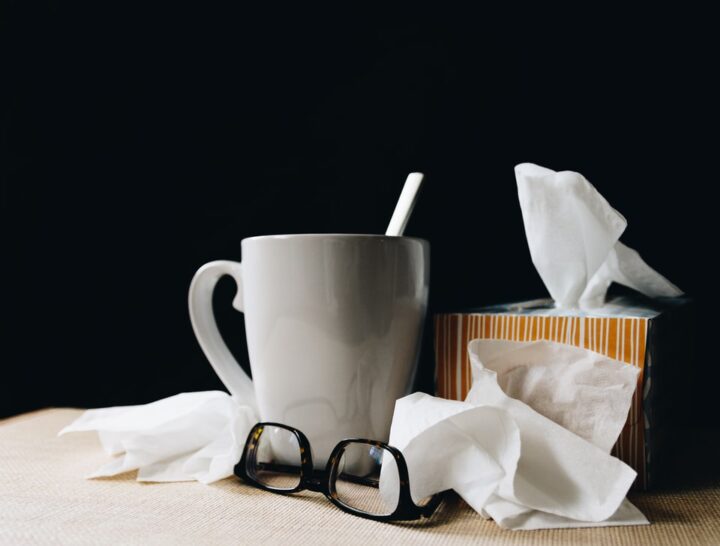 tea cup, tissues, glasses on table