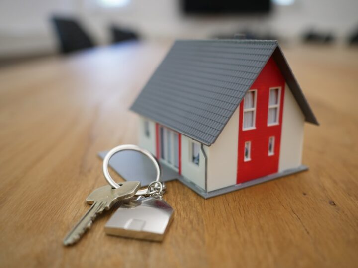 tiny house figurine with a set of keys on a table