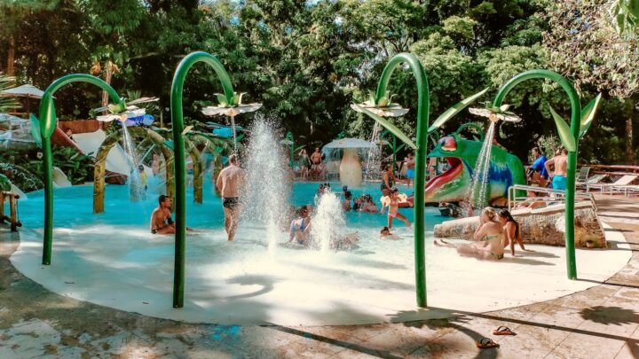 Outdoor Spray Park with children playing in bathing suits.