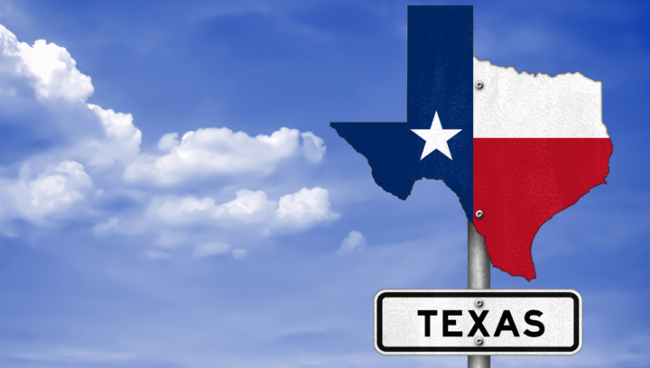 sign showing state of Texas against blue sky