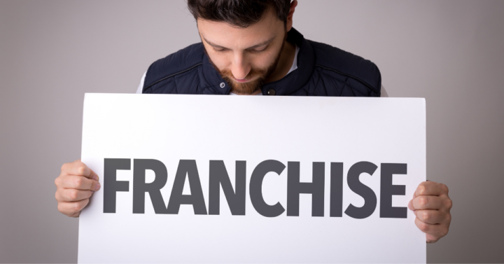 Man holding Franchise sign