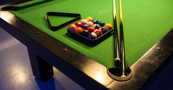 Pool Table with Balls and Cue Sticks