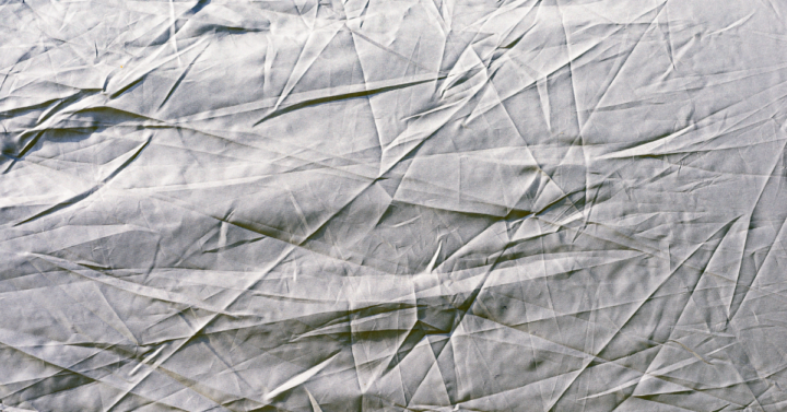 A photo of a wrinkled bed sheet