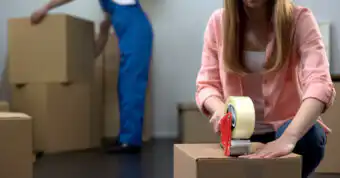 photo of someone taping a box