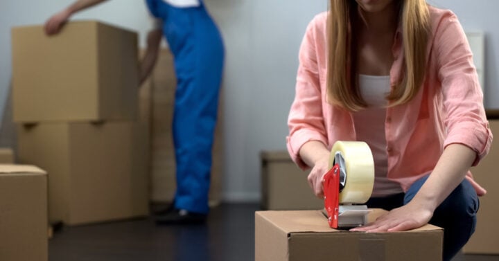 photo of someone taping a box
