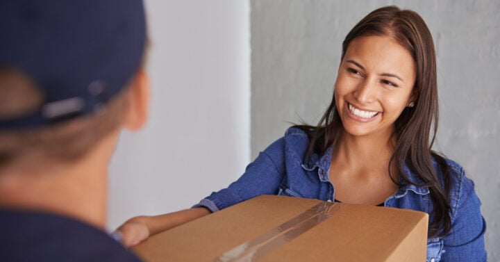 photo of a woman holding a moving box