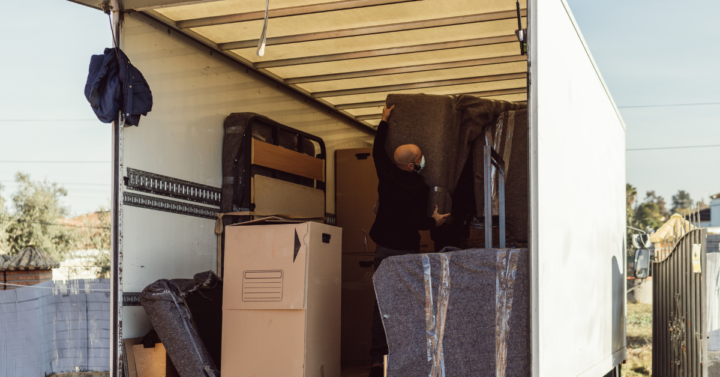 photo of someone putting something into a moving truck