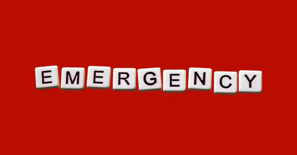Emergency spelled out in scrabble letters on a red background