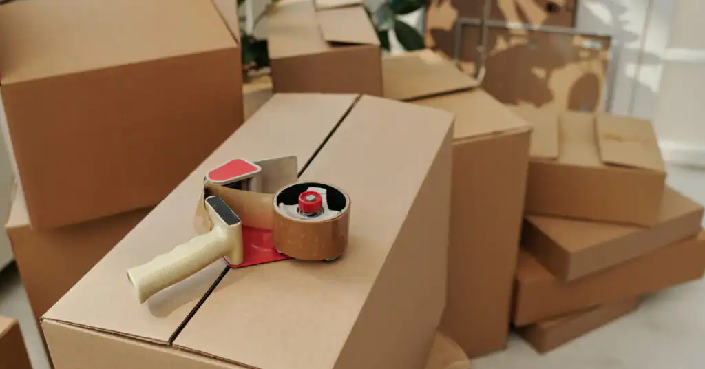 Piles of moving boxes and packing tape