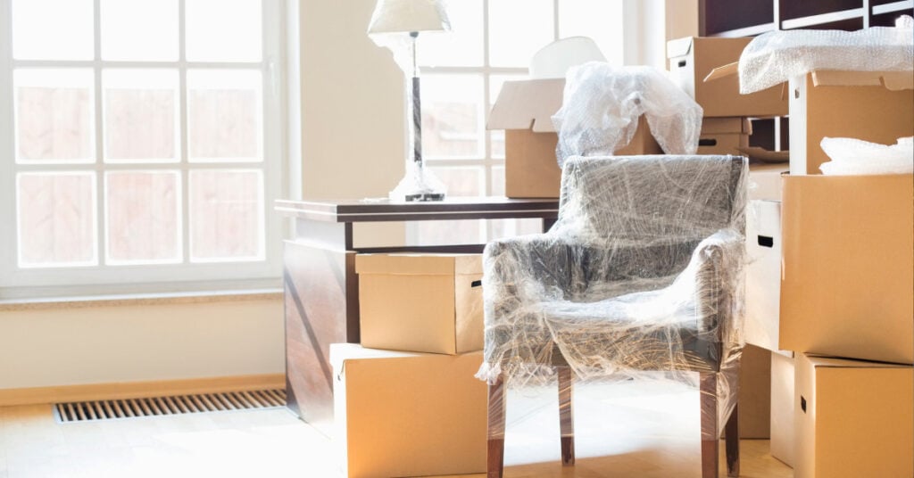 Stack of moving boxes and wrapped furniture