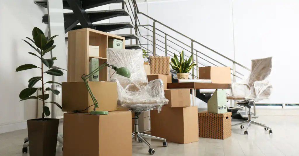 Moving boxes and office supplies wrapped and ready to be moved.