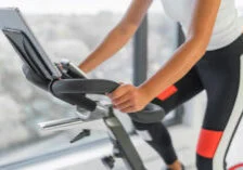 Image shows a person riding an exercise bike