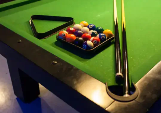 Pool Table with Balls and Cue Sticks