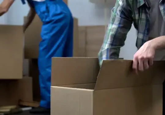 Photo of person packing a box