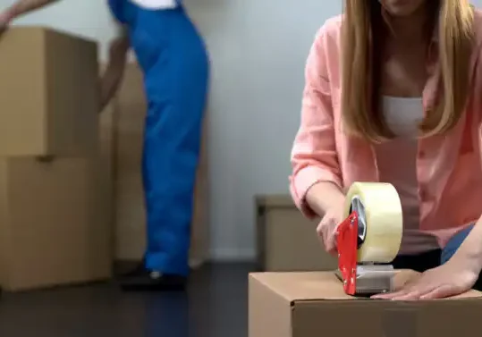 photo of someone taping a box