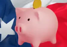 a piggy bank in front of a waving Texan flag