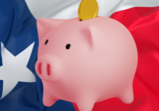 a piggy bank in front of a waving Texan flag